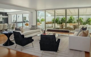 Modern living room with neutral toned furniture and outdoor patio