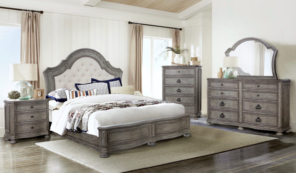 The Colton Creek bedroom by Avalon Furniture is made with sandblasted pecan veneers in a Gray wood finish.